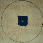 One hole for the circle guide, one for the cutting tool